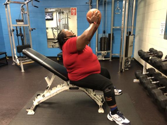 Woman at the gym with a basketball.