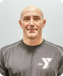 A personal trainer photo of Tom Fegert, personal trainer at the Ragsdale YMCA. He is smiling at the camera.