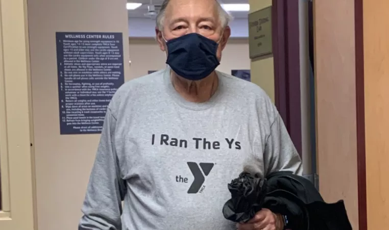 man holds jacket at the y