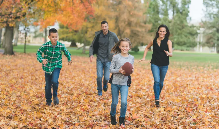 A family of four enjoying fall activities