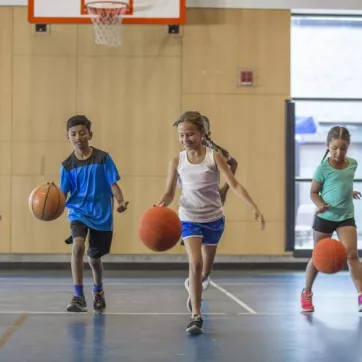 kids dribbling basketballs