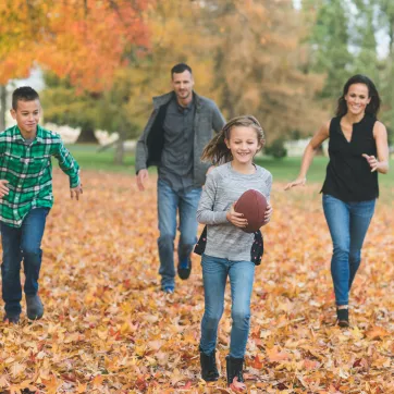 A family of four enjoying fall activities