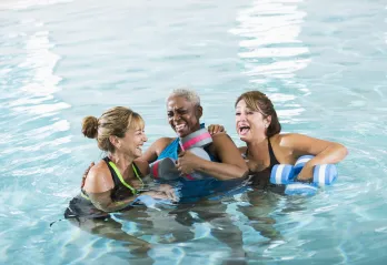 A group of women enjoying a water fitness class.