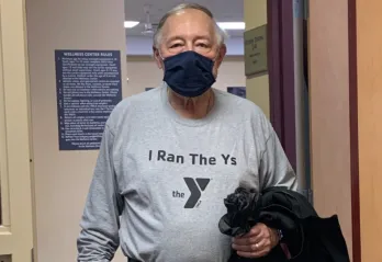 man holds jacket at the y