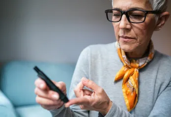 Woman doing diabetes blood test at home