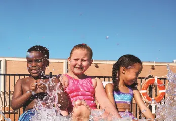 A group of children at the edge of a pool during a Safety Around Water class.