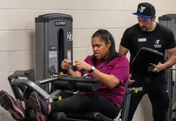 Personal trainer assisting their trainee 
