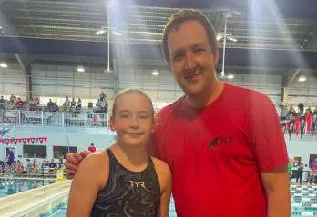 GCY Swim member and coach posing for a photo