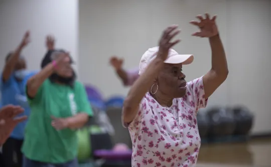 A senior woman working out during a SilverSneakers group exercise class at the Hayes-Taylor YMCA.