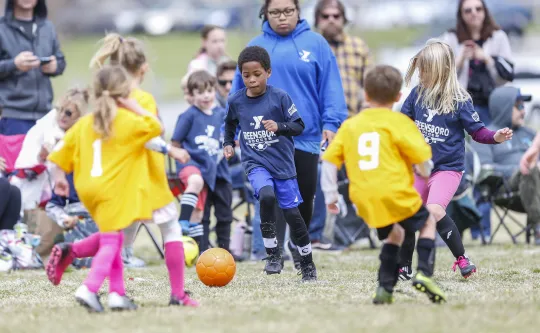 A group of children at the Spears YMCA playing soccer.