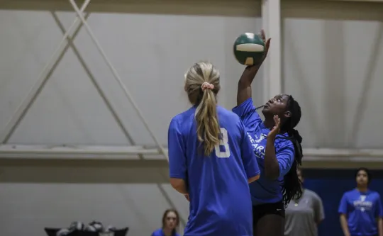Two volleyball players playing volleyball at the Spears Family YMCA.