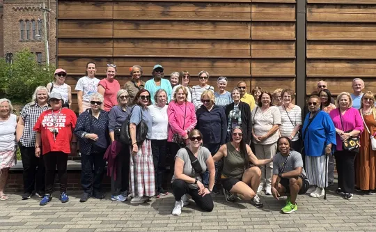 An outdoor group photo of people on a YMCA of Greensboro Active Older Adults trip.