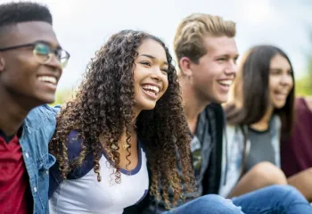 A group of teens laughing together.