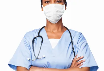 A doctor standing with her arms crossed.