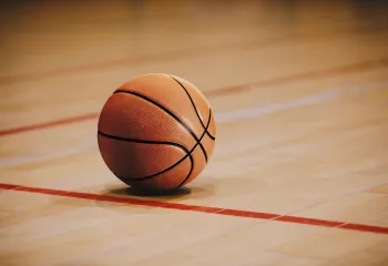 A basketball on a gymnasium floor.