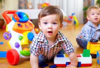Two babies playing with toys.