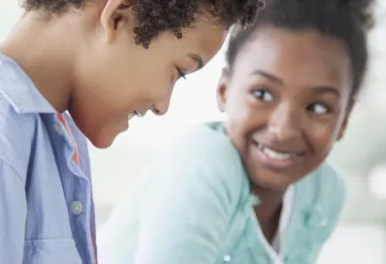 A boy and girl playing chess.