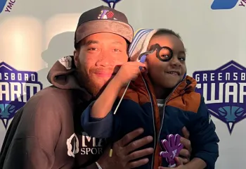 Man and child smiling at Y Night - Greensboro Swarm