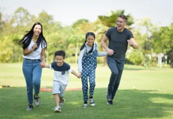 Asian family having fun outside