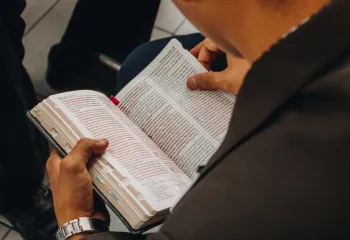 Overhead view of guy reading bible