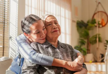 A caregiver embracing their loved one