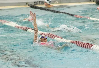 young swimmer competing on swim team