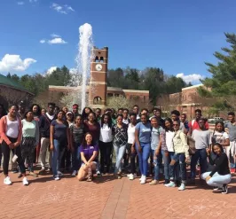 A group of teenagers standing outside.