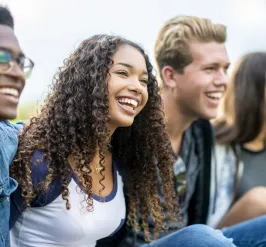 A group of teens laughing together.