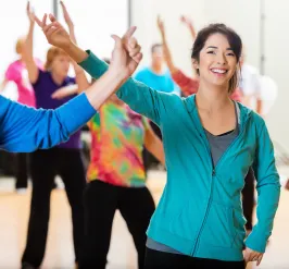 A group of people smiling and laughing while dancing.