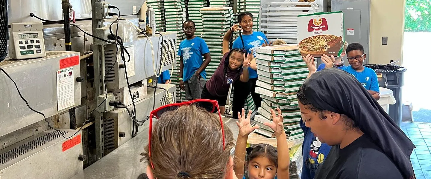 Kids cooking pizza at Marco's Pizza