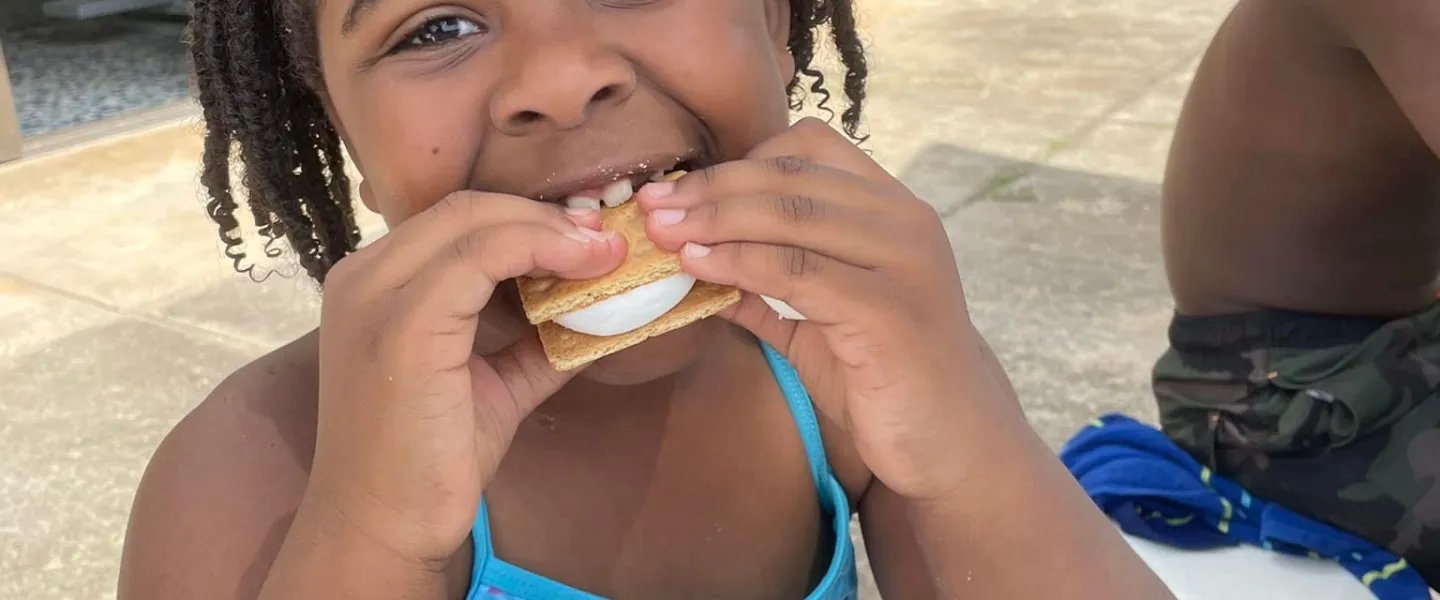 Camper eating s'mores
