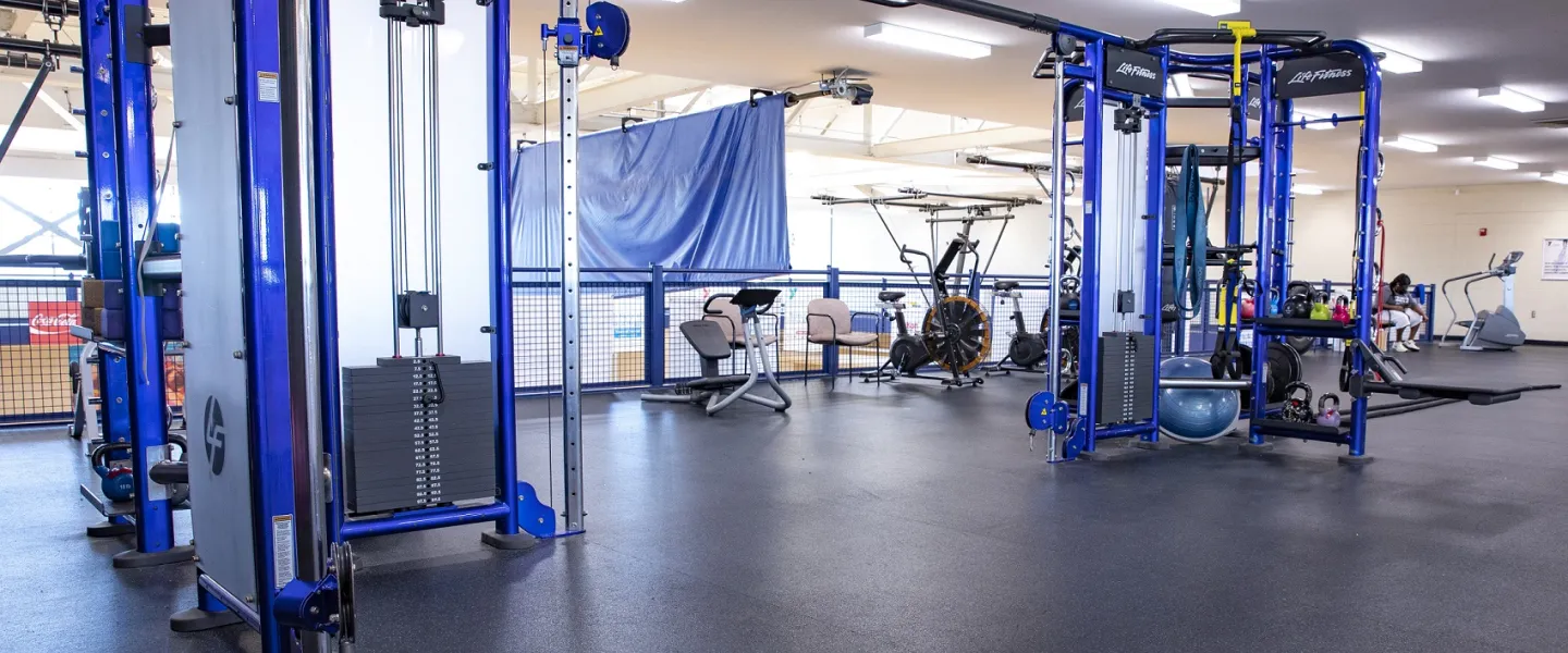 An area with several weight lifting machines at the Bryan YMCA.