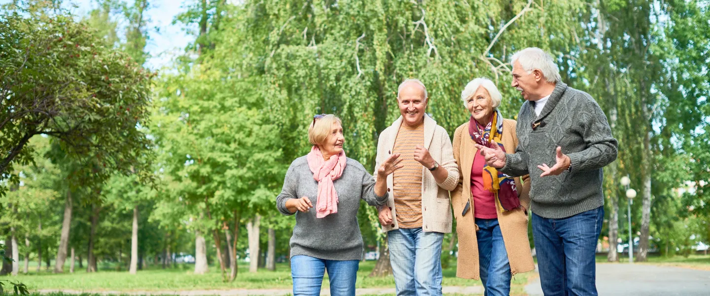 A group of senior friends walking outdoors together.