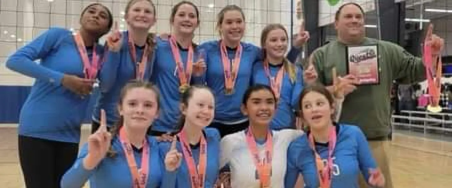 A photo of the 13 Legacy team winning a gold medal.