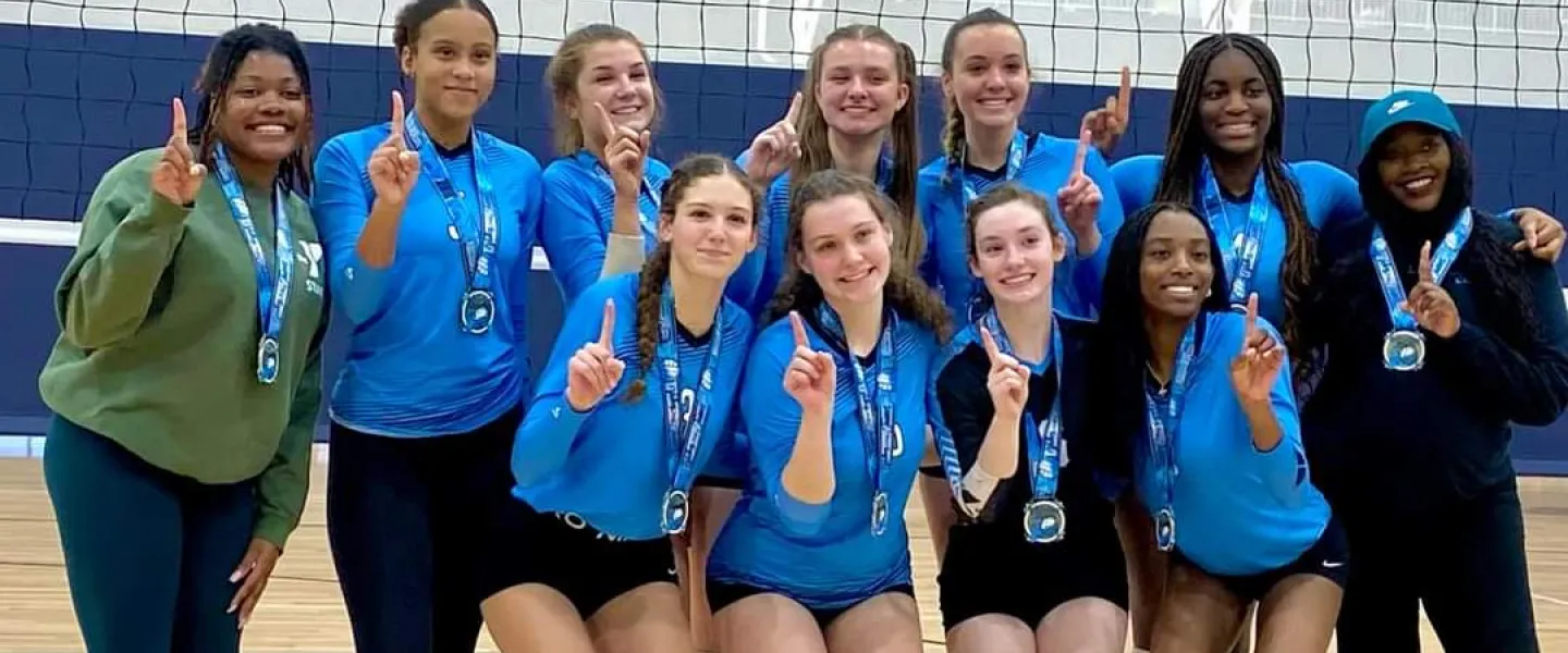 A photo of the Carolina Spike Force 16 Legacy team winning a gold medal.