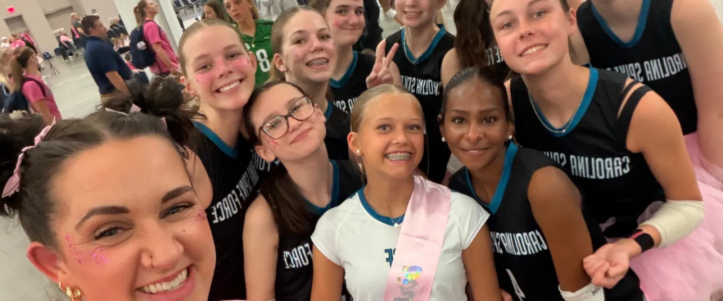Carolina Spike Force volleyball athletes group photo in pink spirit wear