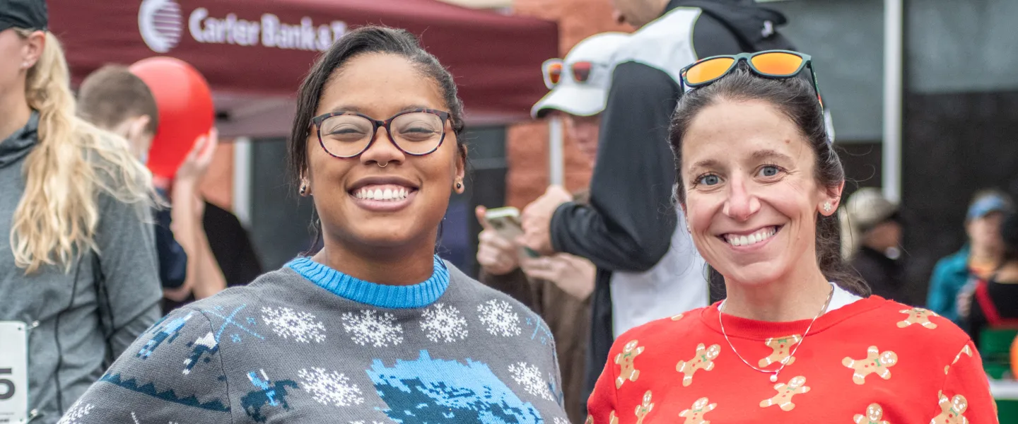 Two participants at the Ragsdale YMCA Reindeer Romp. They are smiling at the camera.