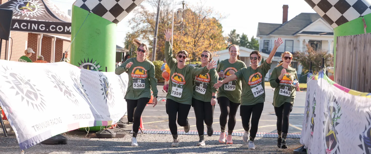 A group of women running together during the Reidsville YMCA Turkey Trot. They are at the finish line.
