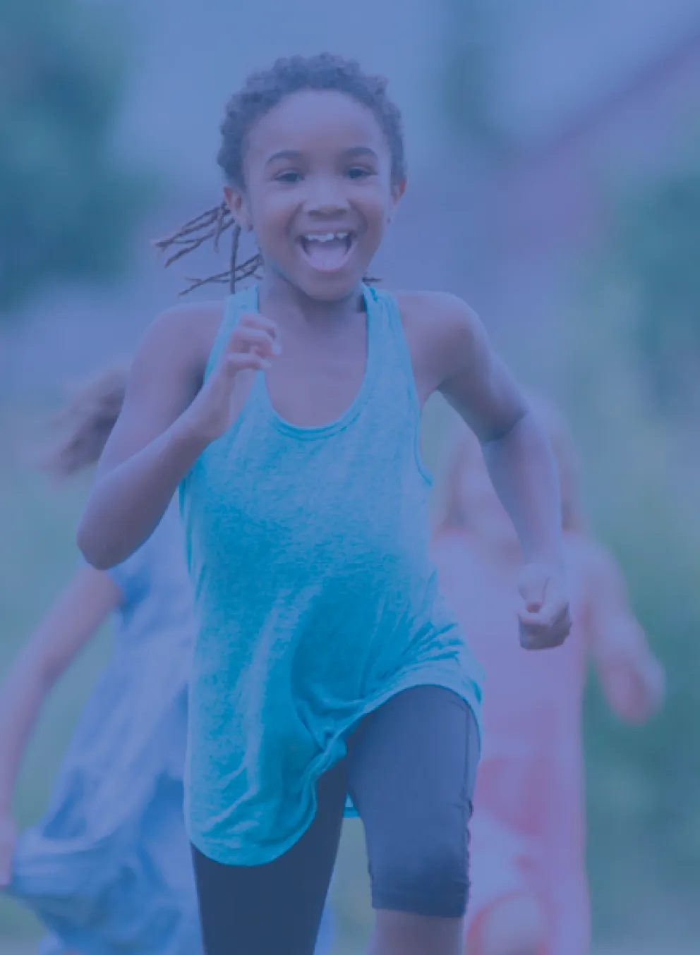 A group of children smiling and laughing as they play outside. They are running toward the camera. The photo is covered in a dark blue overlay.