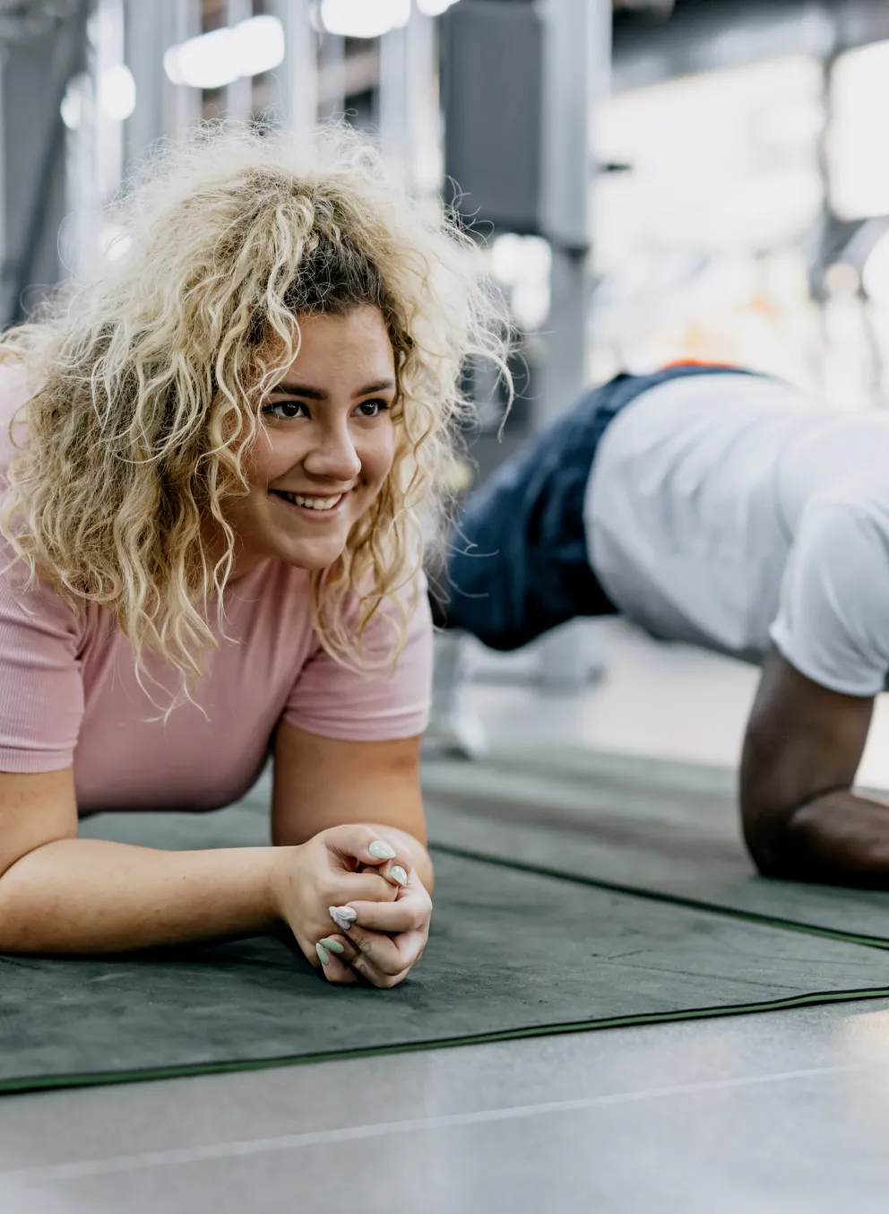woman and man doing planks at gym during personal training
