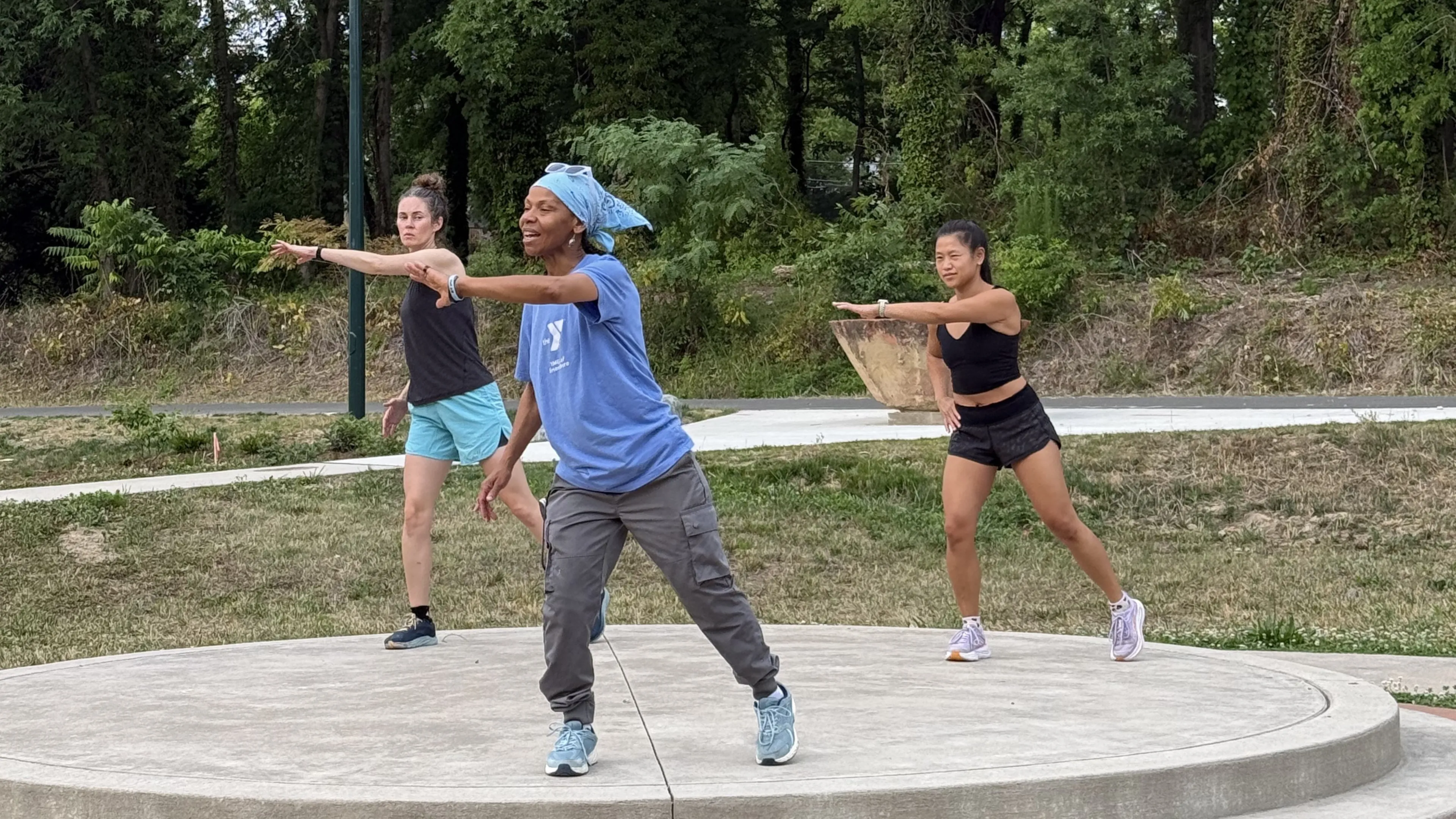 Three people working out along the Greenway in Greensboro