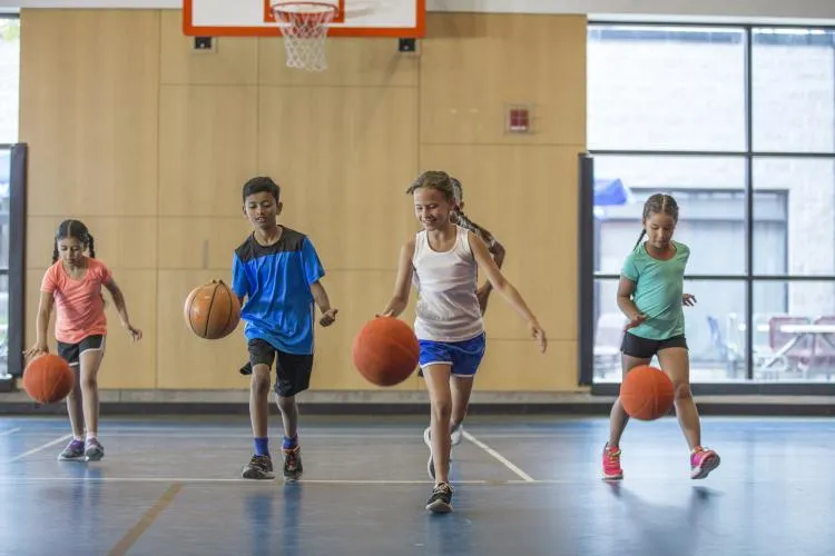 kids dribbling basketballs