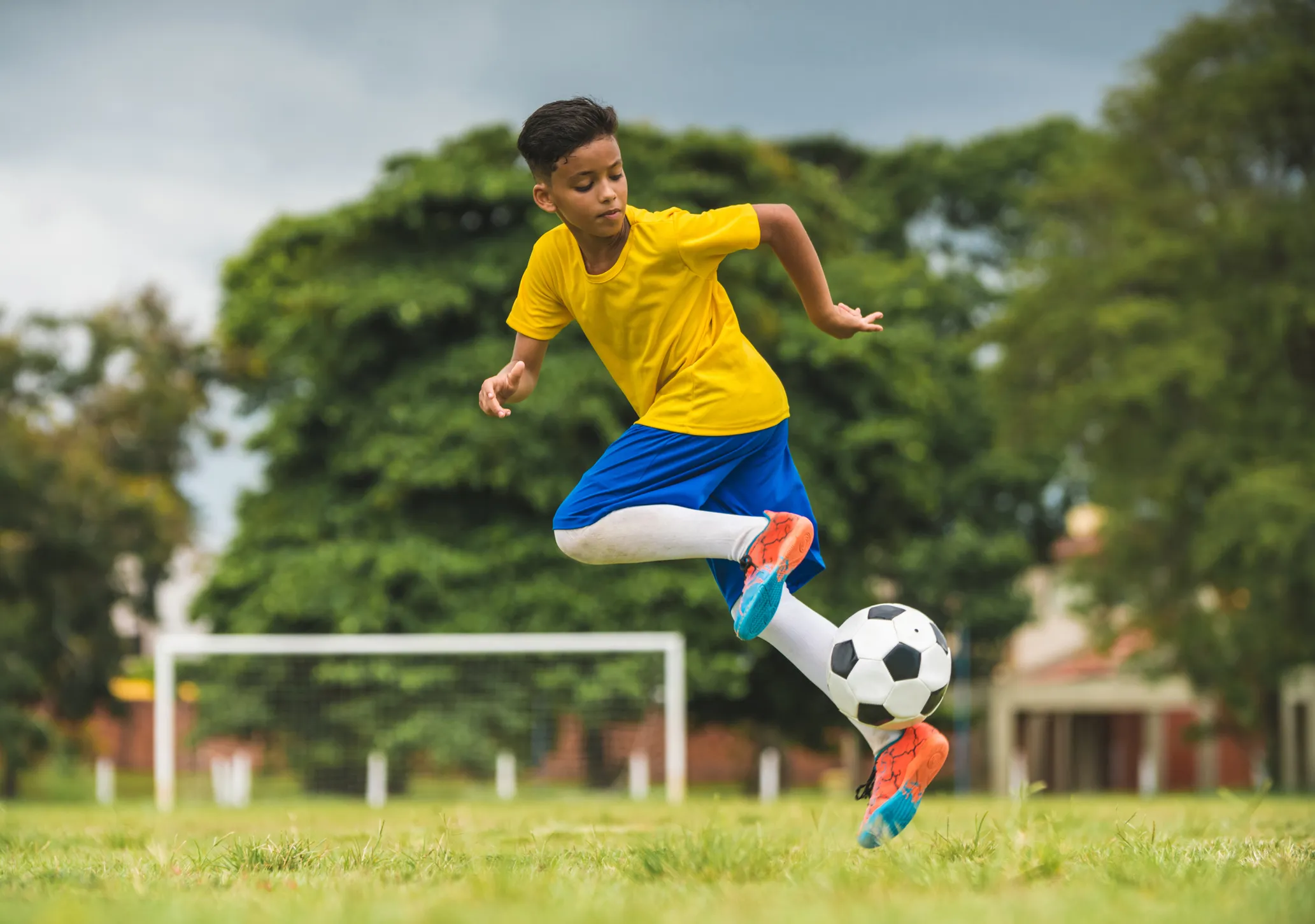 A boy running while playing soccer.