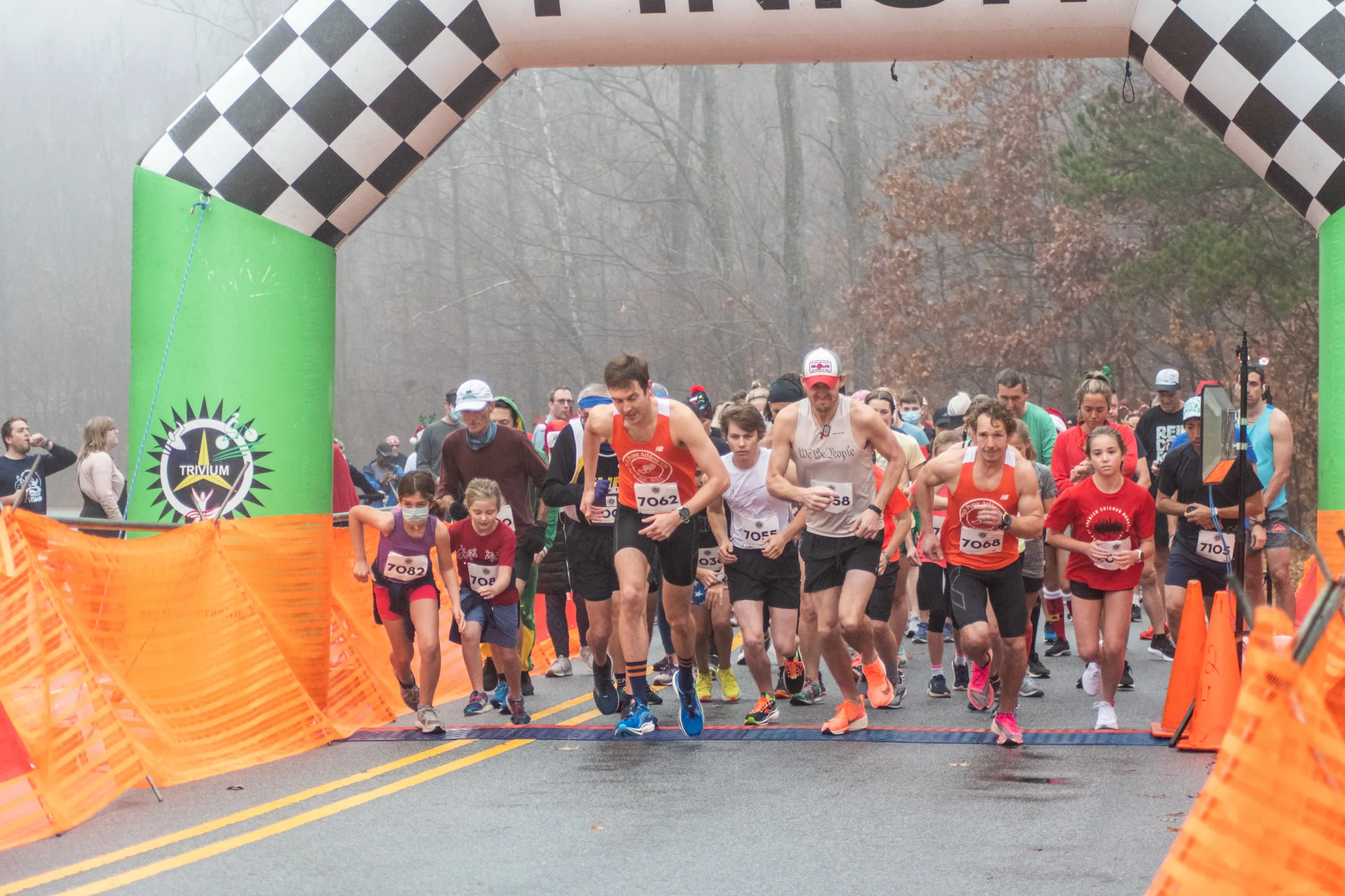 The starting line at the Ragsdale YMCA's Reindeer Romp road race. A crowd of runners are running toward the camera.