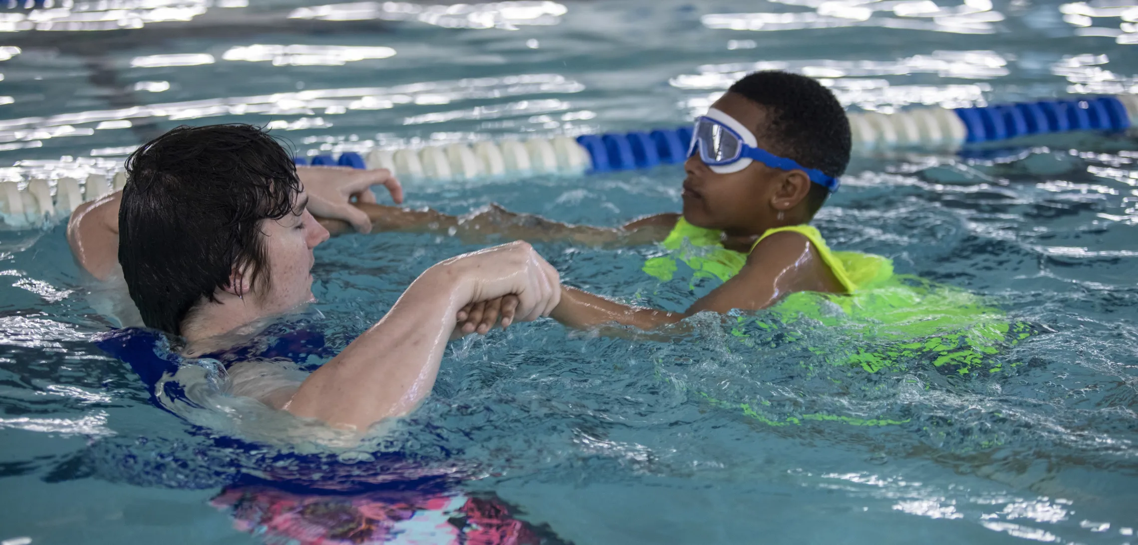 A child learning to swim in group swim lessons at the Ragsdale YMCA.