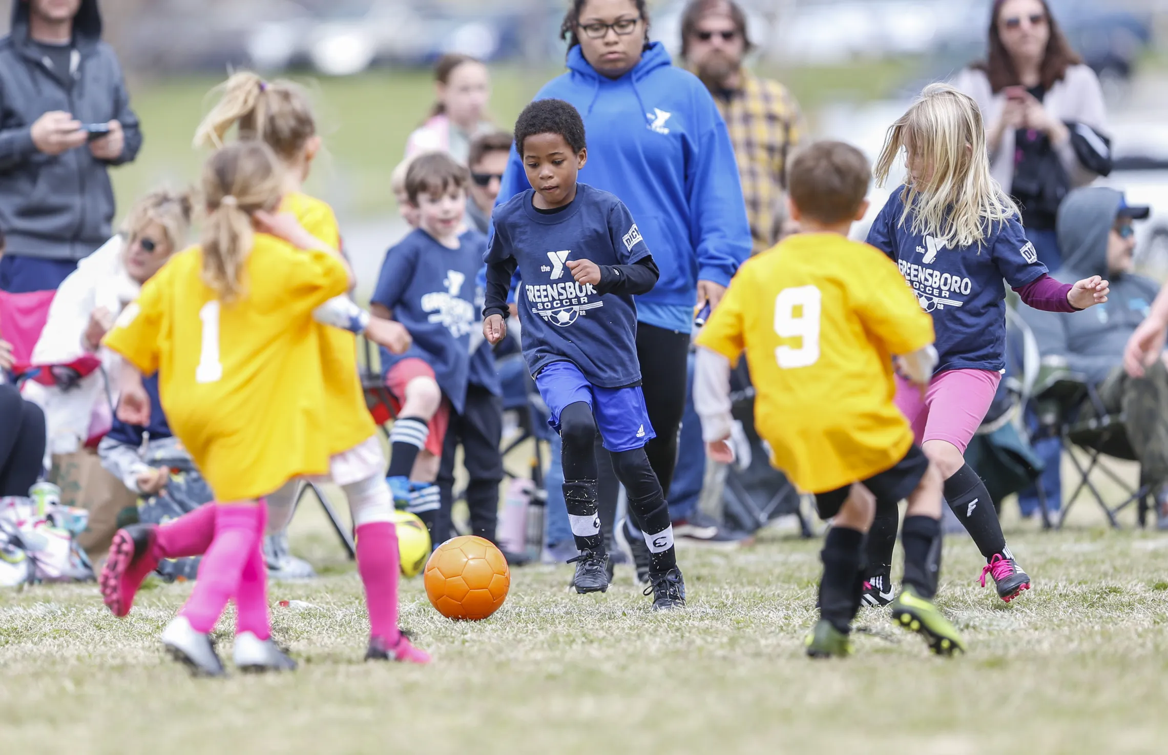 A group of children at the Spears YMCA playing soccer.
