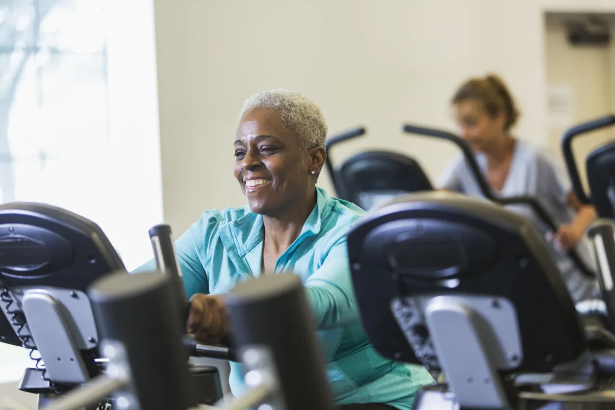 Senior african american woman at gym on exercise bike