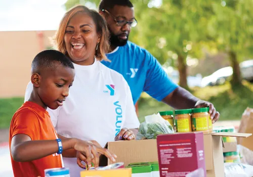 Three people volunteering at the YMCA of Greensboro