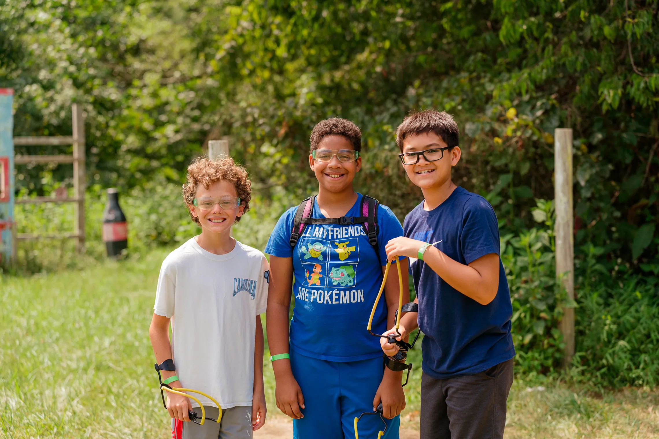 A group of three boys at Camp Weaver. They are smiling at the camera.