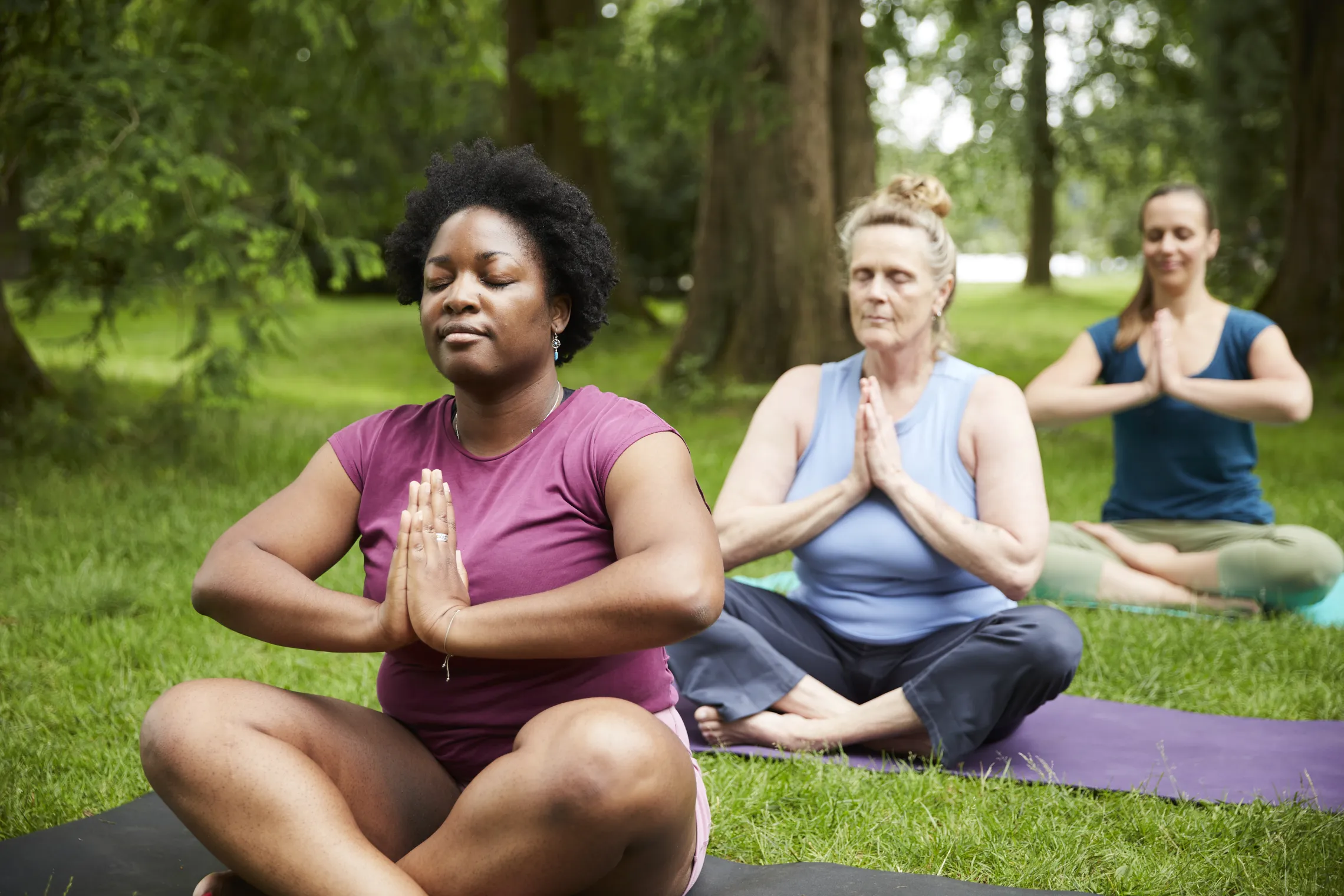People doing yoga in the park